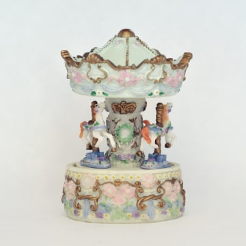 Music box with spinning carousel.