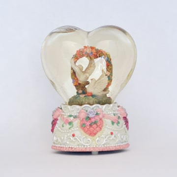 Music box with doves in heart-shaped snowglobe.